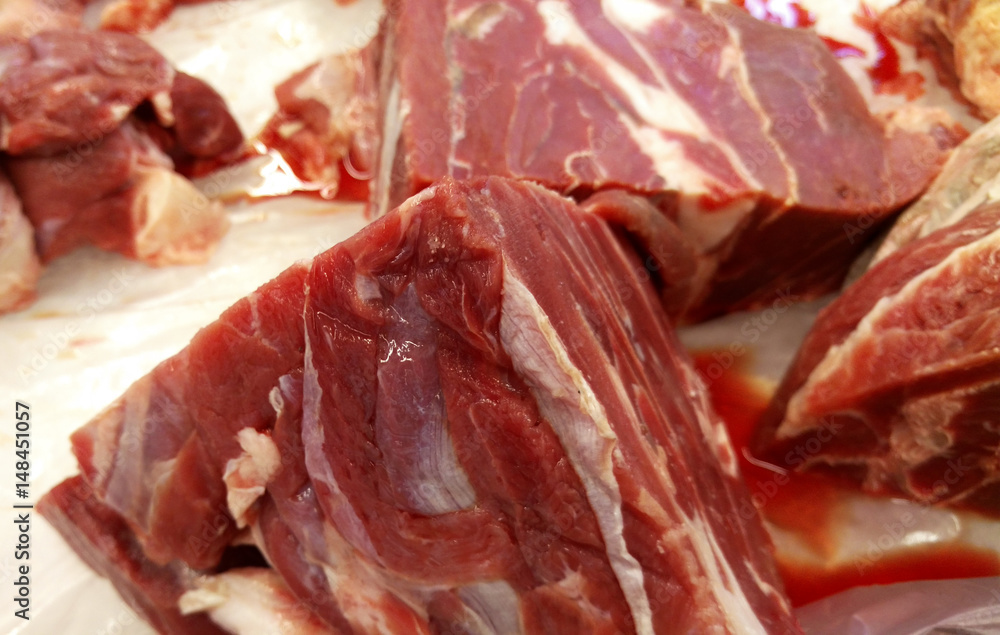 Frozen meat cut into pieces and allowed to to melt on the table. Frozen meat cut into pieces and allowed to to melt on the table.