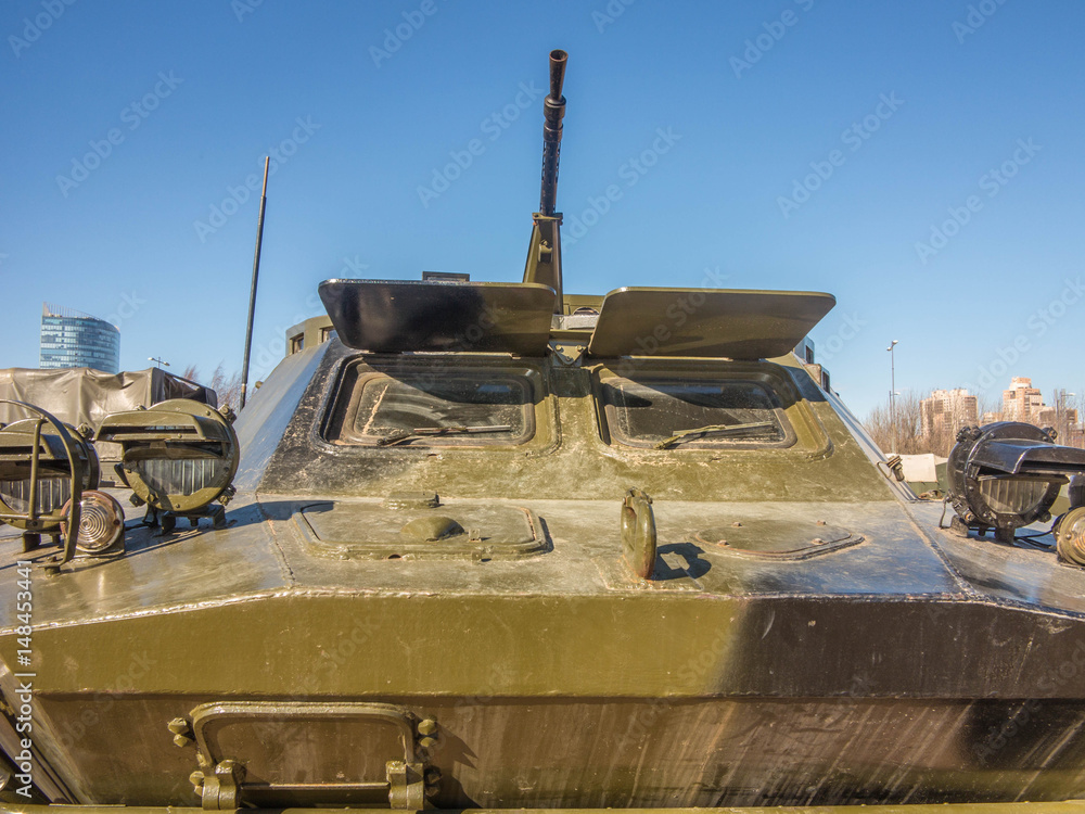 Armored personnel carrier on sand against the blue sky