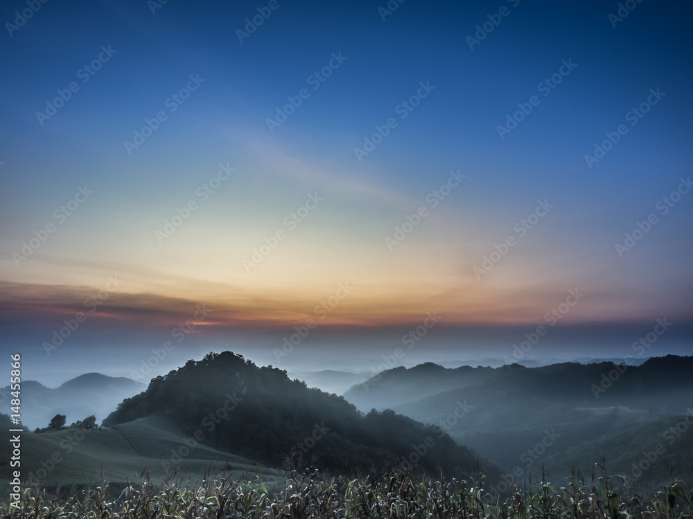 Landscape layers during sunset with motion blur effect for background purpose. At top of national park in northern of Thailand,  while twilight. Abstract motion blur with fog and cloudy around valley