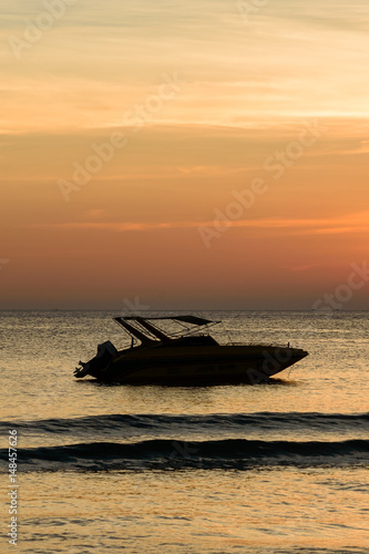 Boat shadow in sea with sunset