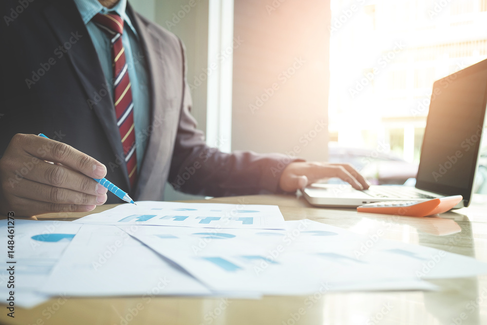 Business concept, Young business man's hands working with laptop and document graph on wood table. Business concept, Young business man's hands working with laptop and document graph on wood table.
