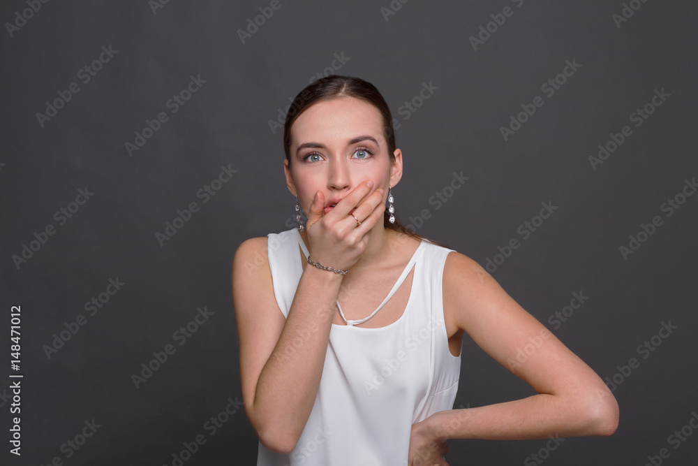 Shocked woman covering mouth with hands Shocked woman covering mouth with hands