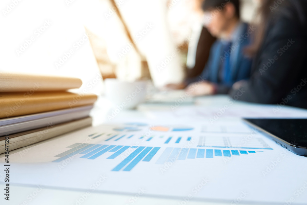 Business people discussing the charts and graphs showing the results of their successful teamwork, business concept. blurred background. Business people discussing the charts and graphs showing the results of their successful teamwork, business concept. blurred background.