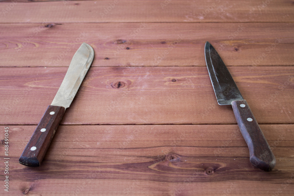 Kitchen knives on a table. Wooden background.