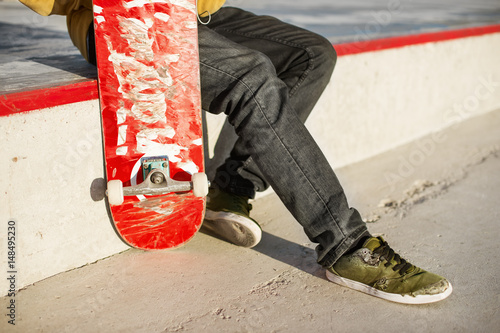 Close-up of skateboarders foot while skating in skate park