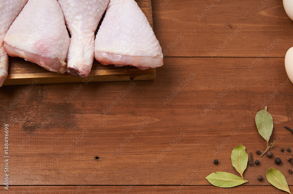 Fototapeta premium Chicken shin on the wooden table