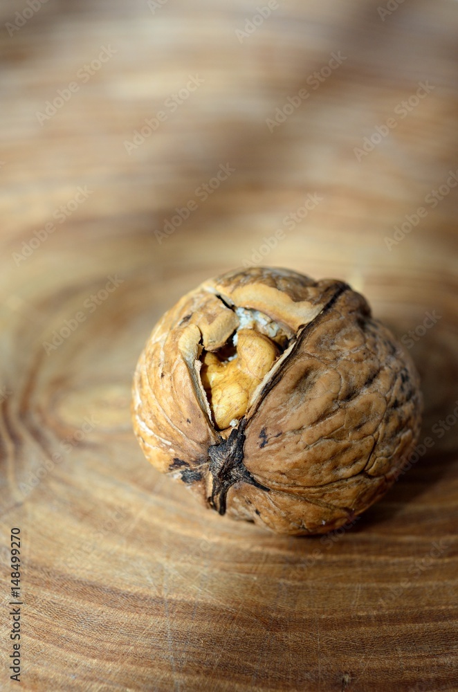 Fototapeta premium Broken walnut on surface wood of radial cut 