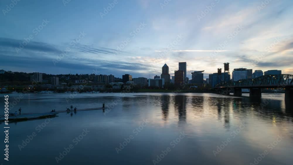 Moving clouds and blue sky over Portland OR downtown city skyline along Willamette River waterfront from sunset into blue hour with water reflection 4k uhd time lapse Moving clouds and blue sky over Portland OR downtown city skyline along Willamette River waterfront from sunset into blue hour with water reflection 4k uhd time lapse