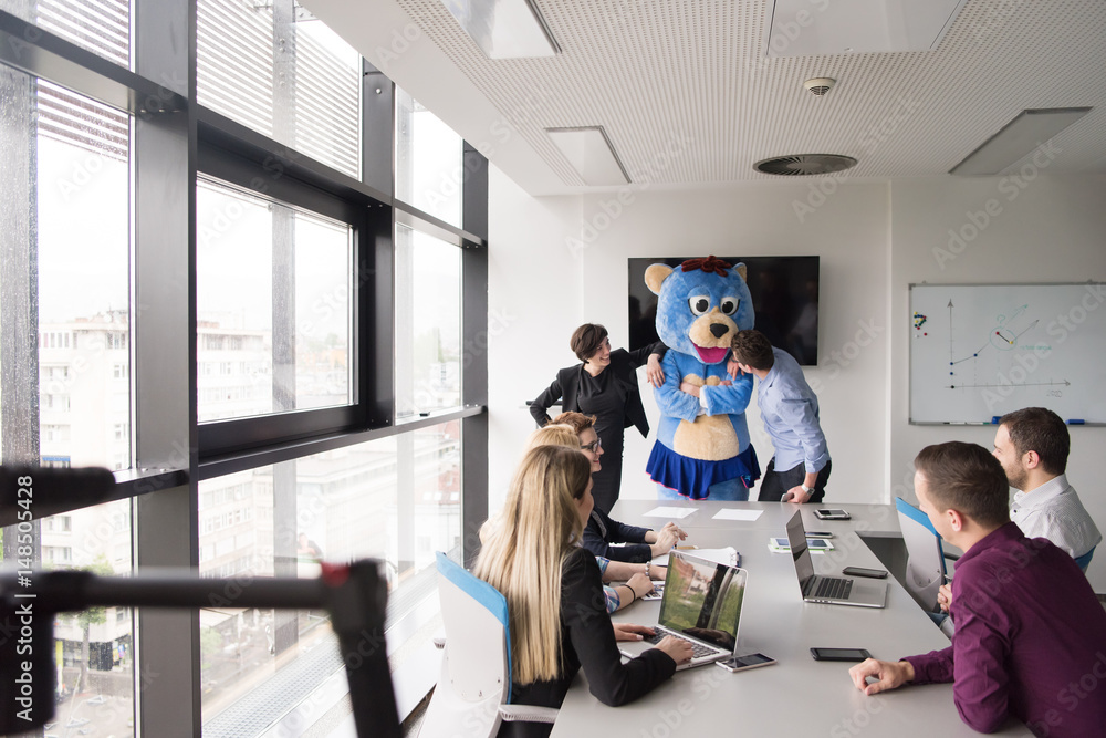 boss dresed as bear having fun with business people in trendy office boss dresed as bear having fun with business people in trendy office