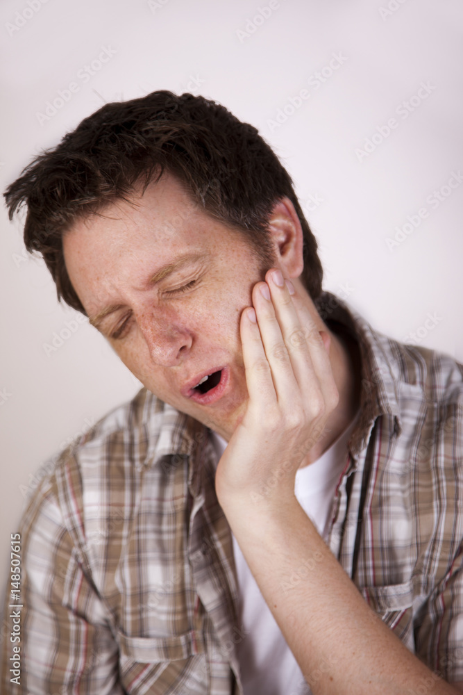 man holding face in pain