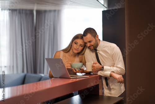 A young couple is preparing for a job and using a laptop