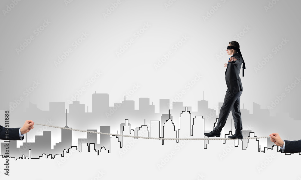 Business concept of risk support and assistance with man balancing on rope Business concept of risk support and assistance with man balancing on rope