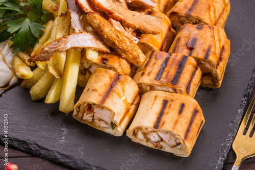 The chicken fillet fried on coals, wrapped in shawarma with pickles and vegetables

