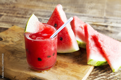 Fresh water melon smoothie on a wooden background, rural style, selective focus 
