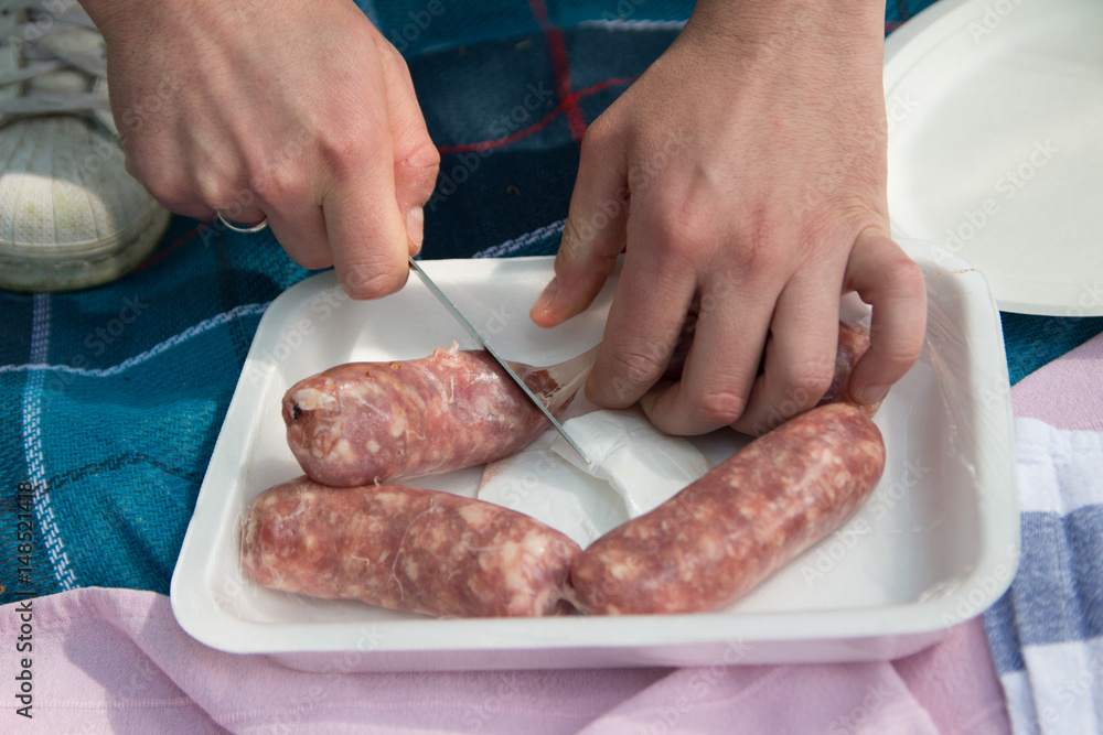 Homemade white sausage out pigs meat cutted with knife
