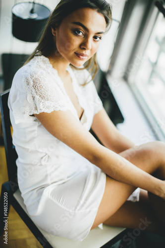 Young woman sitting by the ...