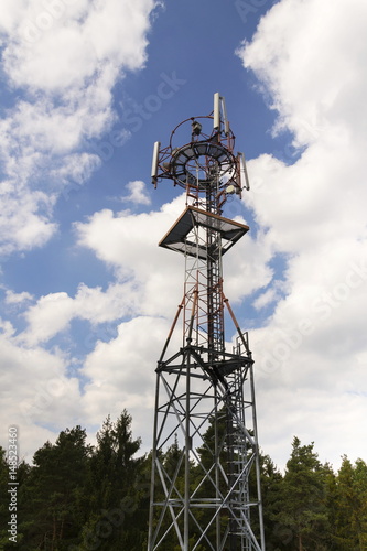 Transmitters and aerials on telecommunication tower during sunset