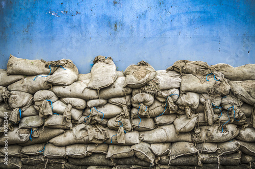 Tableau sur toile Old sandbag wall for flooding defense or fortification,