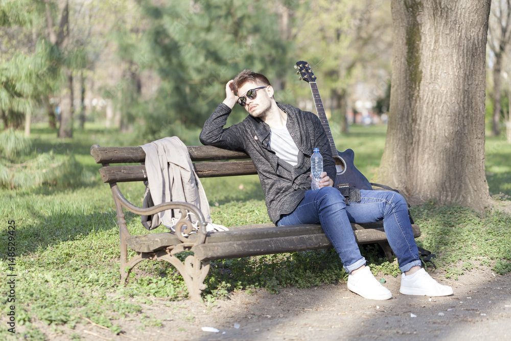 Young man with an acoustic guitar Young man with an acoustic guitar