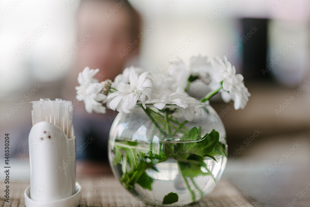 Vase with flowers in a cafe