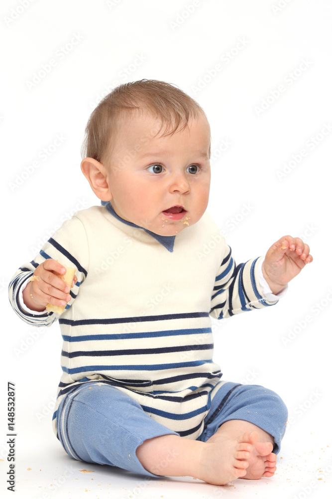 Baby dresses in fisherman surprised with a biscuit Baby dresses in fisherman surprised with a biscuit