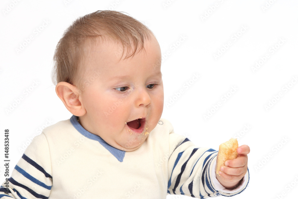 Baby gourmand looks his biscuit Baby gourmand looks his biscuit