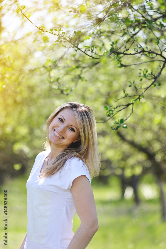 Blonde is walking in the spring in the park. Blonde is walking in the spring in the park.