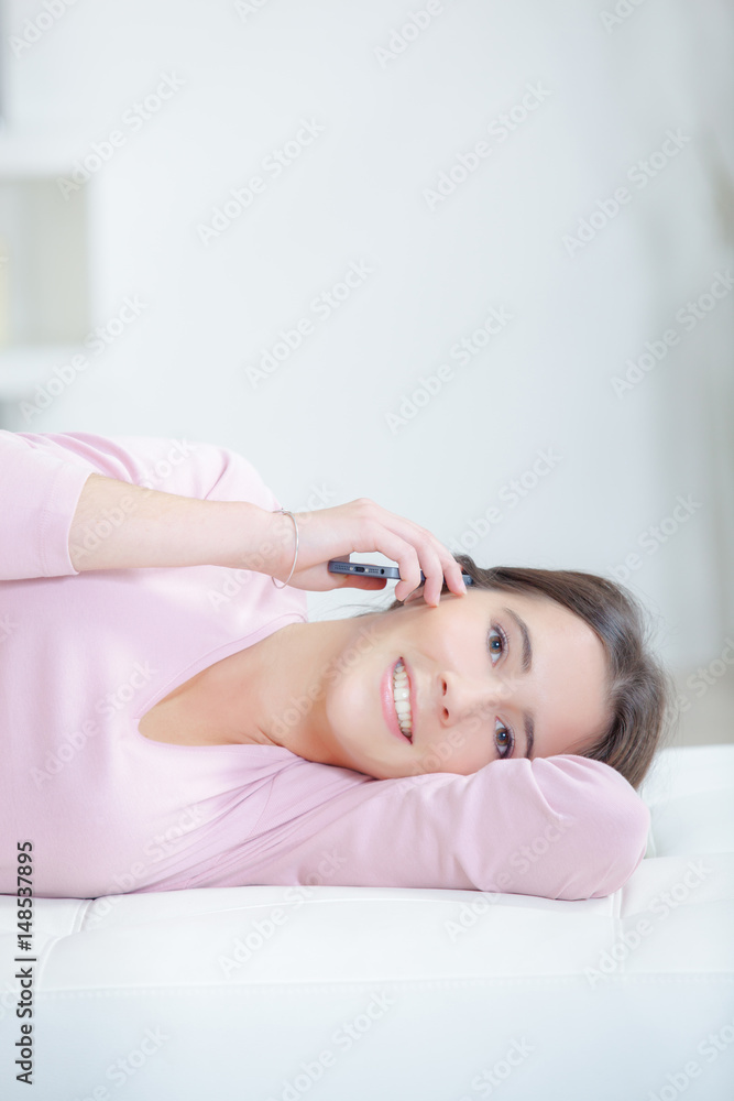 Young woman relaxing and phoning Young woman relaxing and phoning