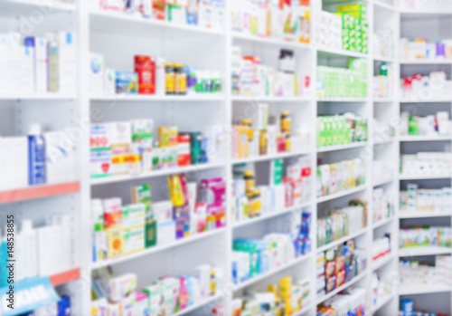 Medicines arranged in shelves at pharmacy out of the focus  Pharmacy background photo