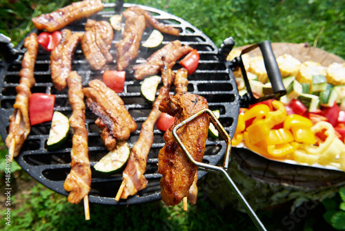 Meat and vegetables during grilling. Assorted types of bacon