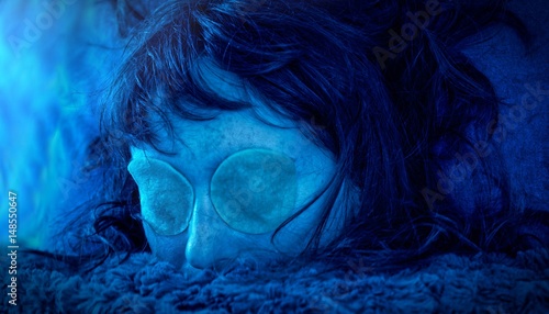 Closeup portrait of a scary medusa underwater woman without eyes. Bright blue light 