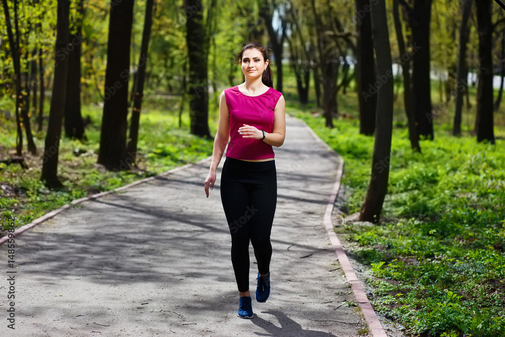 Young pretty fit woman jogging in the park. Young pretty fit woman jogging in the park.