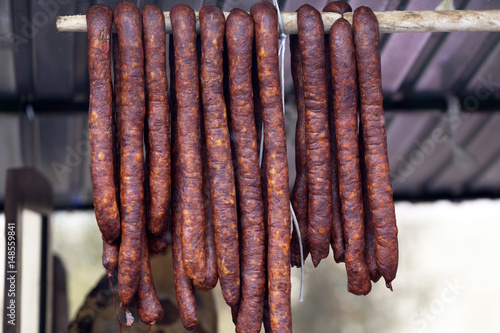 Home made smoked sausage hanging on the stall in a street market