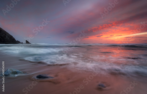 Contrast of a stormy sunset on isolated and nature beach