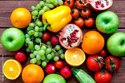 diet food with fresh fruits and vegetables salad wooden background top view