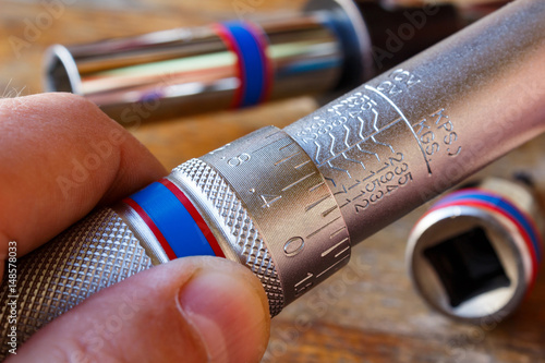 Torque wrench adjusting by mechanic in the workshop