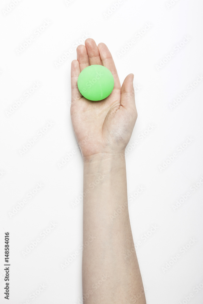 woman hand hold a fluorescence green ball isolated white, background. woman hand hold a fluorescence green ball isolated white, background.