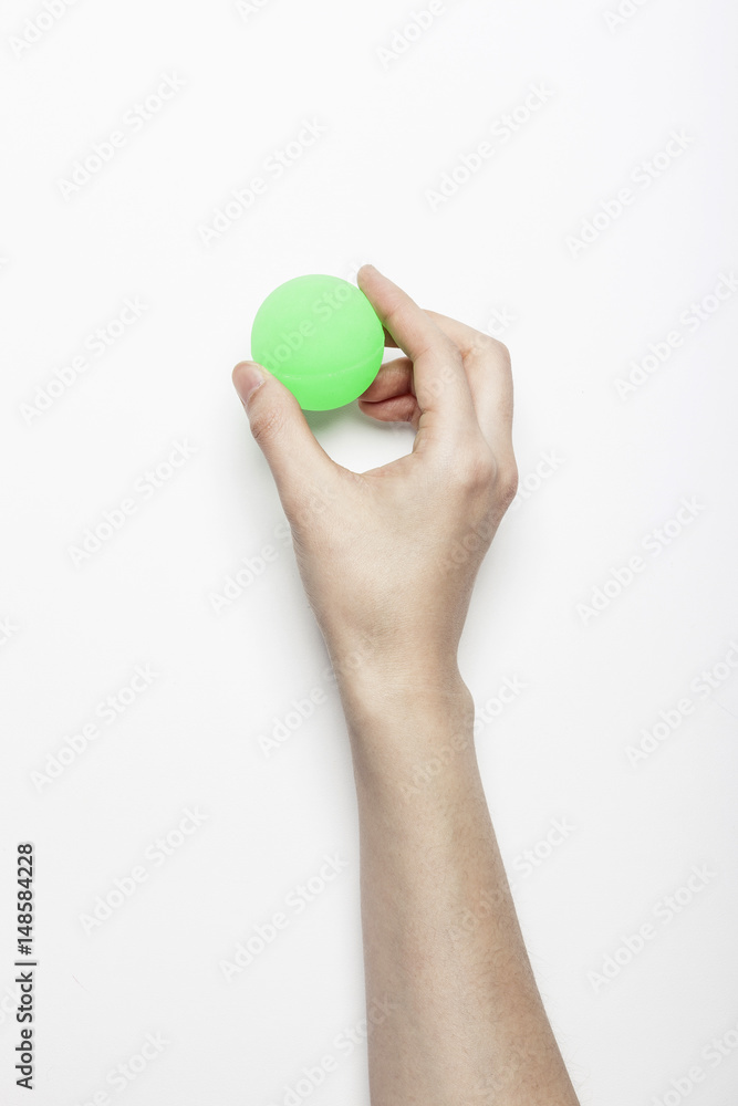 woman hand hold a fluorescence green ball isolated white, background. woman hand hold a fluorescence green ball isolated white, background.