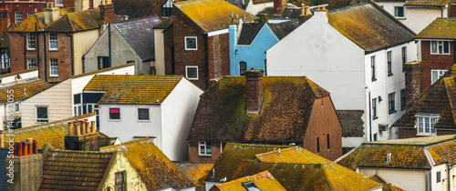 Wallpaper Mural Roofs of buildings covered with green moss, seaside spot seen from the bird's eye view, beautiful typical English architecture Torontodigital.ca