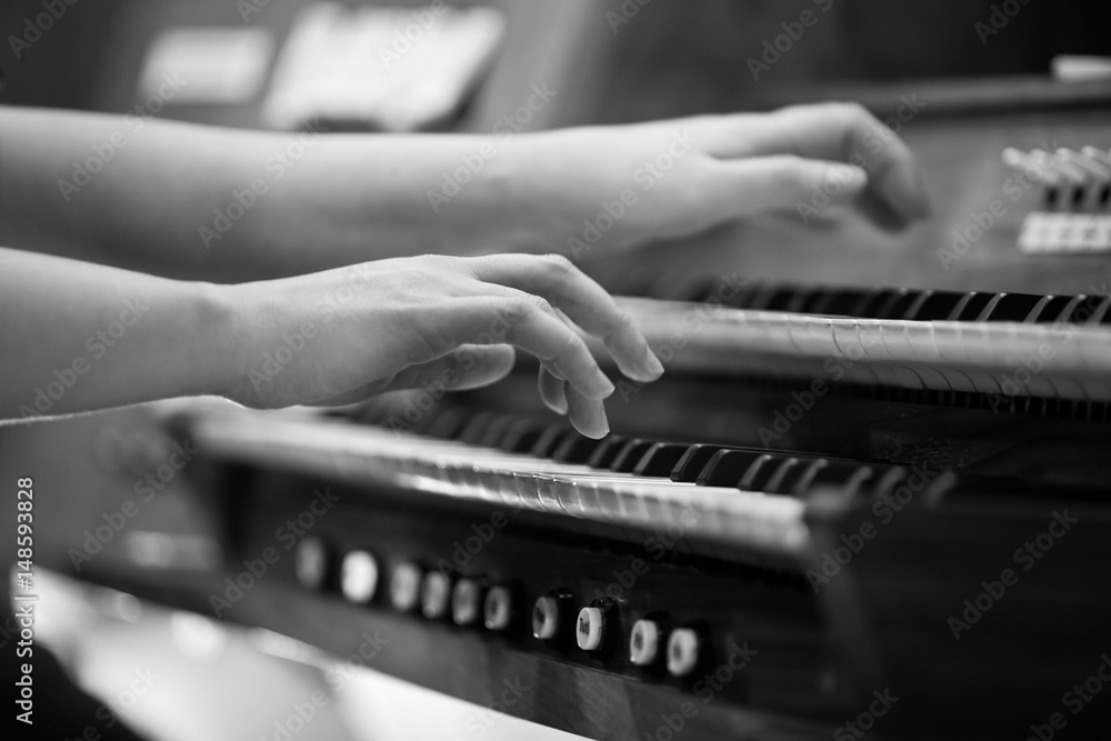 Hands of a woman playing the organ in black and white Hands of a woman playing the organ in black and white