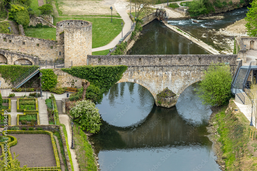 Old medieval bridge in Europe with its reflection on the water. Casemates and stone bridge in Luxembourg Old medieval bridge in Europe with its reflection on the water. Casemates and stone bridge in Luxembourg