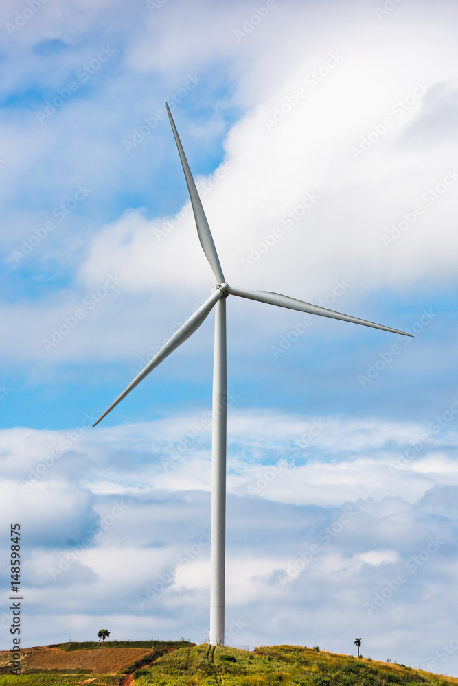 Wind turbines generate electricity to reduce global warming. Located on the hill.