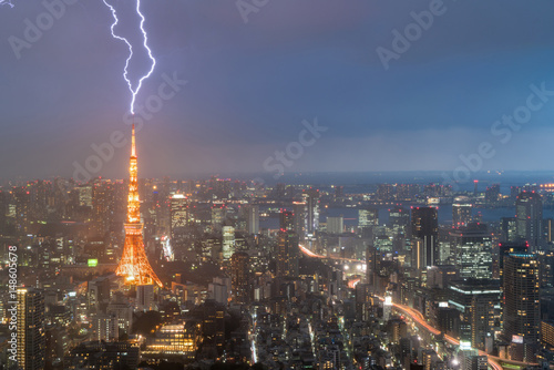 Lightning storm over Tokyo city, Japan in night with thunderbolt over Tokyo tower. Thunderstorm in Tokyo, Japan.