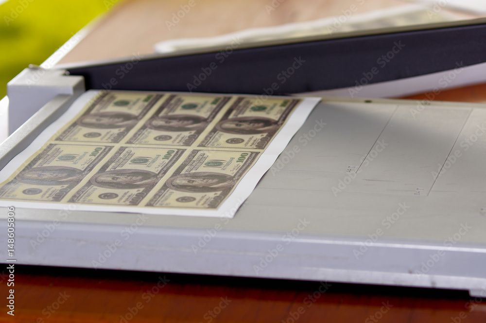 Man using manual paper cutter. Manufacture work, counterfeit money Man using manual paper cutter. Manufacture work, counterfeit money