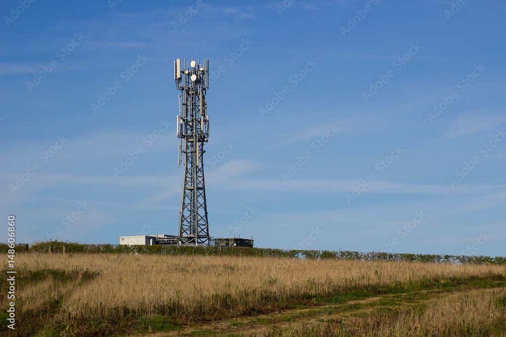 A typical radio and mobile phone network telecommunications tower situate in farmland near Groomsport in County Down, Northern Ireland makes an impressive site against a clear blue sky. A typical radio and mobile phone network telecommunications tower situate in farmland near Groomsport in County Down, Northern Ireland makes an impressive site against a clear blue sky.