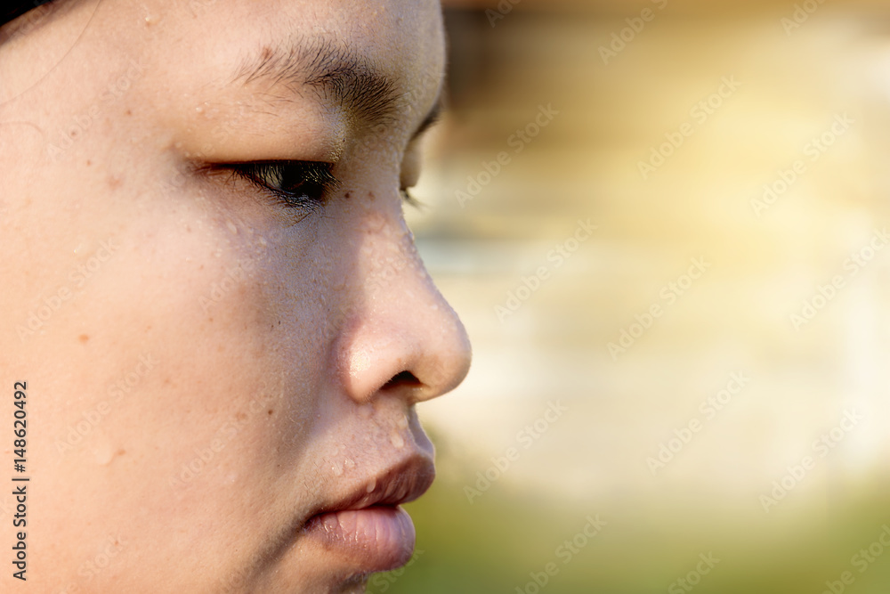 Close-up sweating on face of asian women,exercise on sunset background. copy space Close-up sweating on face of asian women,exercise on sunset background. copy space