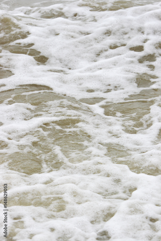 White surf on murky water White surf on murky water