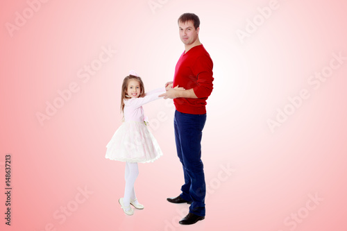 Little girl pulls her hands to his daddy. © lotosfoto