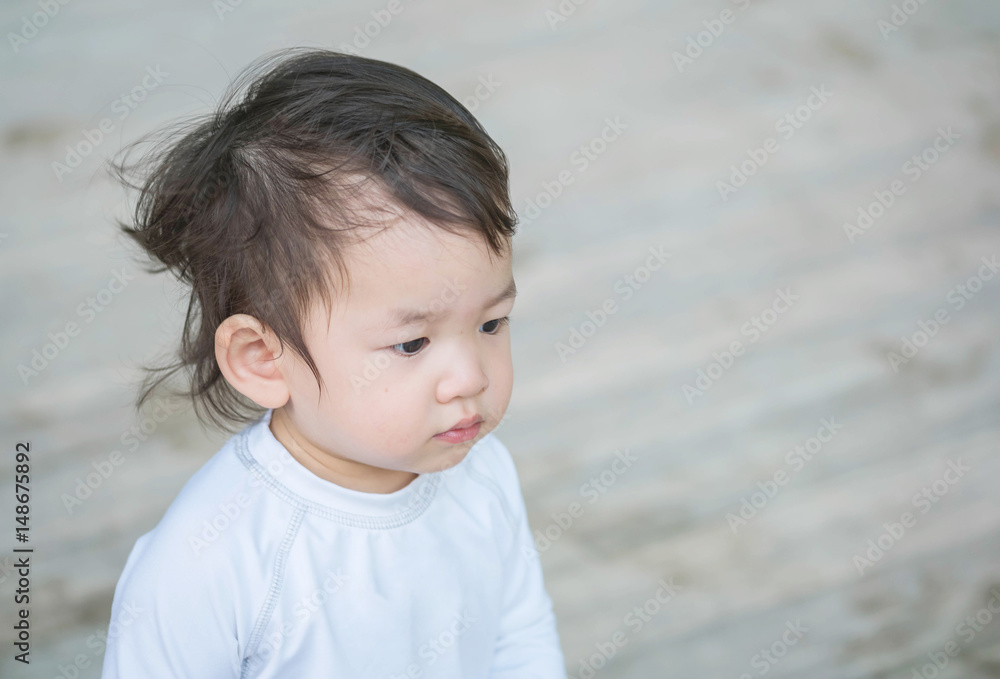 Closeup cute asian kid interest in something emotion with copy space Closeup cute asian kid interest in something emotion with copy space