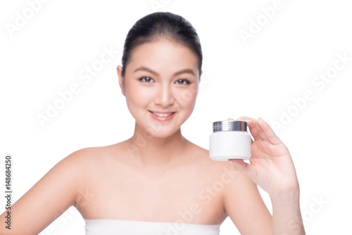 Beauty treatment. Asian woman holding moisturizing cream box.